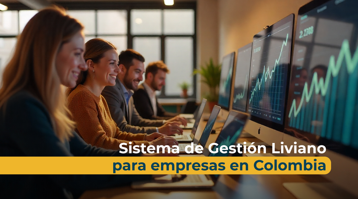 Equipo de trabajo en oficina utilizando computadores con gráficos ascendentes en pantalla, representando productividad y eficiencia con un Sistema de Gestión Liviano para empresas en Colombia.